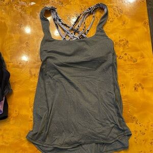 Lululemon size 8 army green tank with snake-like digital print on bra section.